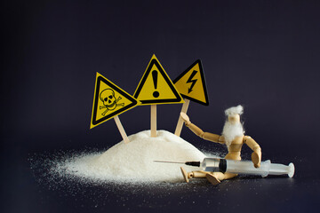 A depressed person next to a large pile of granulated sugar. Warning about the dangers of...