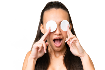 Young Arabian woman over isolated chroma key background with cotton pad for removing makeup from her face