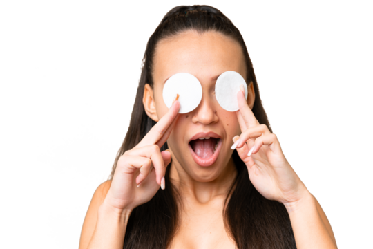 Young Arabian woman over isolated chroma key background with cotton pad for removing makeup from her face