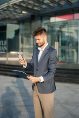 Young business man leader entrepreneur, professional manager holding digital tablet computer
