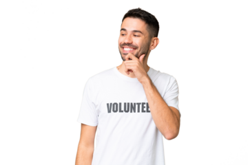 Young volunteer caucasian man over isolated chroma key background looking to the side and smiling