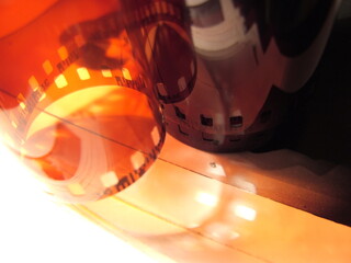 Vintage film reel and canister resting on a wooden surface, capturing the nostalgia of analog photography