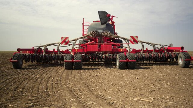 A modern air seeder stands in a field