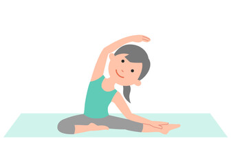 ヨガマットの上で、ヨガのポーズをする女性