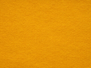 A warm embrace of golden hues, the felt surface radiates a cozy, soft texture and a simplistic, minimalist style