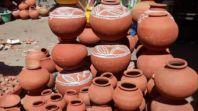 Clay water pots (matkas) displayed for sale in an open market during summer, promoting traditional eco-friendly cooling methods in rural and urban India