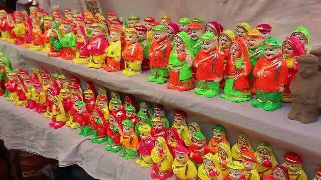 Colorful clay idols of Gan and Gaur for Gangaur festival displayed at a local stall