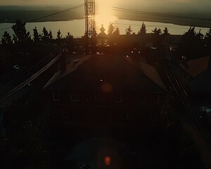 An aerial view of a house and the setting sun