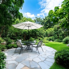 Obraz premium Relaxing outdoor patio scene with a beige umbrella, metal table and chairs on a flagstone patio surrounded by lush green landscaping.