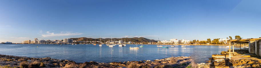 Sant Antoni de Portmany is a vibrant harbour with yachts and pleasure boats anchored in blue...