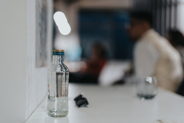 Business meeting in modern office with bottle and blurred background