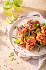 Crispy roasted chicken leg with sauces and lime.
