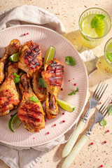 Hot grilled chicken leg with spices and herbs.
