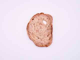 Thin slice of white bread, on a white surface, top view, close-up