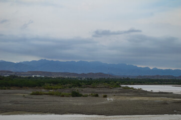 rain water river flowing landscape with mountains and clouds