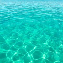 Turquoise water surface with sunlight reflections in a tropical ocean setting
