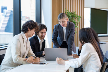 Caucasian woman sale manager is showing annual report chart to her colleagues in executive meeting for next year plan with market share increase for global business and investment