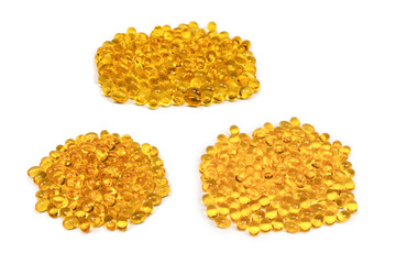 A group of yellow capsules isolated on a white background.