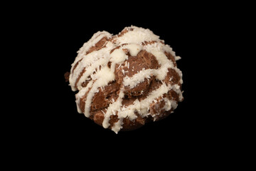 Profiteroles with coconut cream on a black background.