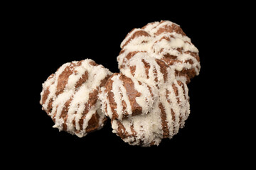 Profiteroles with coconut cream on a black background.
