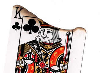Fototapeta premium Close up of a partly burnt playing card on a white background.