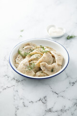 Traditional dumplings served with dill and sour cream