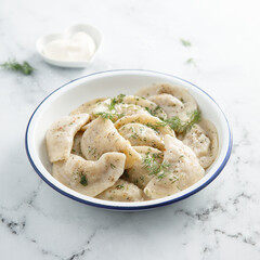 Traditional dumplings served with dill and sour cream