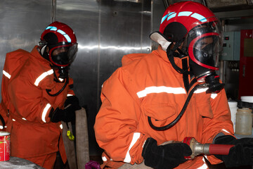 designated fire fighters as per muster list performing gallery fire drill on board ship