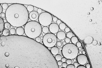Bubble texture macro science experiment,Drop of facial serum with bubbles pouring from transparent...