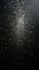 Obraz premium Abstract black background with scattered white powder creating a celestial cosmic dust effect for artistic design and creative projects