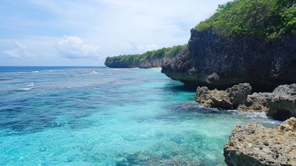 Obraz premium Tropical Coastline, Clear Turquoise Water, Rocky Cliffs, Beach in Background