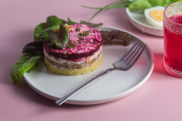 Salad with herring and beets in a plate. Salad Herring under a fur coat
