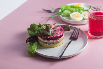 Salad with herring and beets in a plate. Salad Herring under a fur coat
