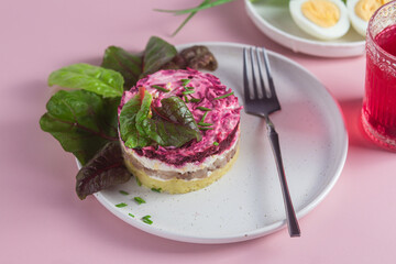 Salad with herring and beets in a plate. Salad Herring under a fur coat