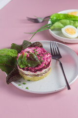 Salad with herring and beets in a plate. Salad Herring under a fur coat