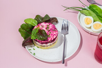 Salad with herring and beets in a plate. Salad Herring under a fur coat