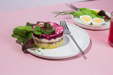 Salad with herring and beets in a plate. Salad Herring under a fur coat