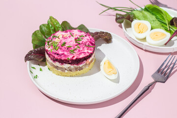 Salad with herring and beets in a plate. Salad Herring under a fur coat