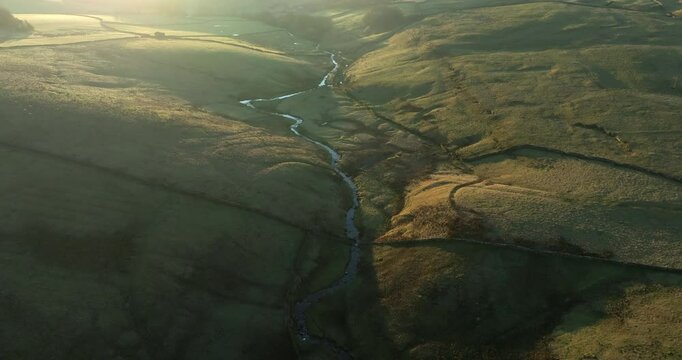 Aerial shot of a sunrise over meandering river in north Yorkshire