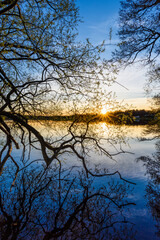 Obraz premium Spring sunrise over the tranquil waters of Åtvidaberg village in Östergötland, Sweden