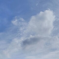 White clouds drifting across a vibrant blue sky