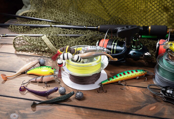 Fishing items laid out on a table against a wooden, old background.