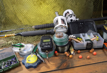 Fishing items laid out on a table against a wooden, old background.