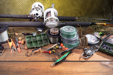 Fishing items laid out on a table against a wooden, old background.