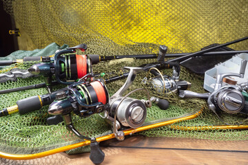 Fishing items laid out on a table against a wooden, old background.