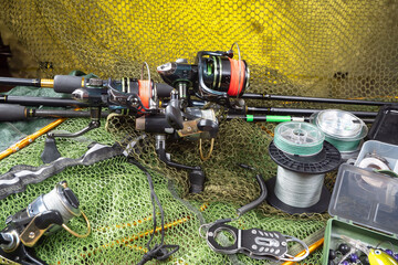 Fishing items laid out on a table against a wooden, old background.