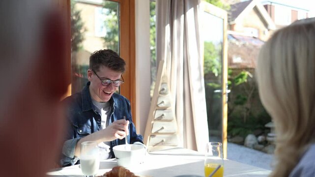Happy couple enjoying breakfast together in sunroom