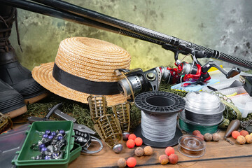 Fishing items laid out on a table against a wooden, old background. © vizafoto