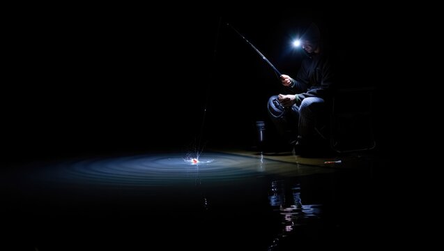 Nighttime fishing activity with artificial light illuminating calm water and angler in dark surroundings Generative AI