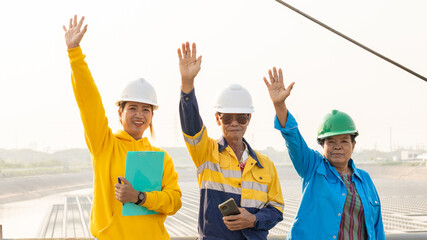 Team of Construction Workers Waving From a Project Site During Daytime, Showcasing Camaraderie and Teamwork © Happy Photo